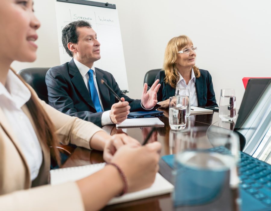 Senior Managers Sitting Down During An Important Interactive Mee Male and female senior managers sitting down during an important interactive meeting in the conference room of a successful corporation